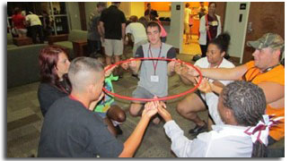 Students sitting in a circle holding a ring